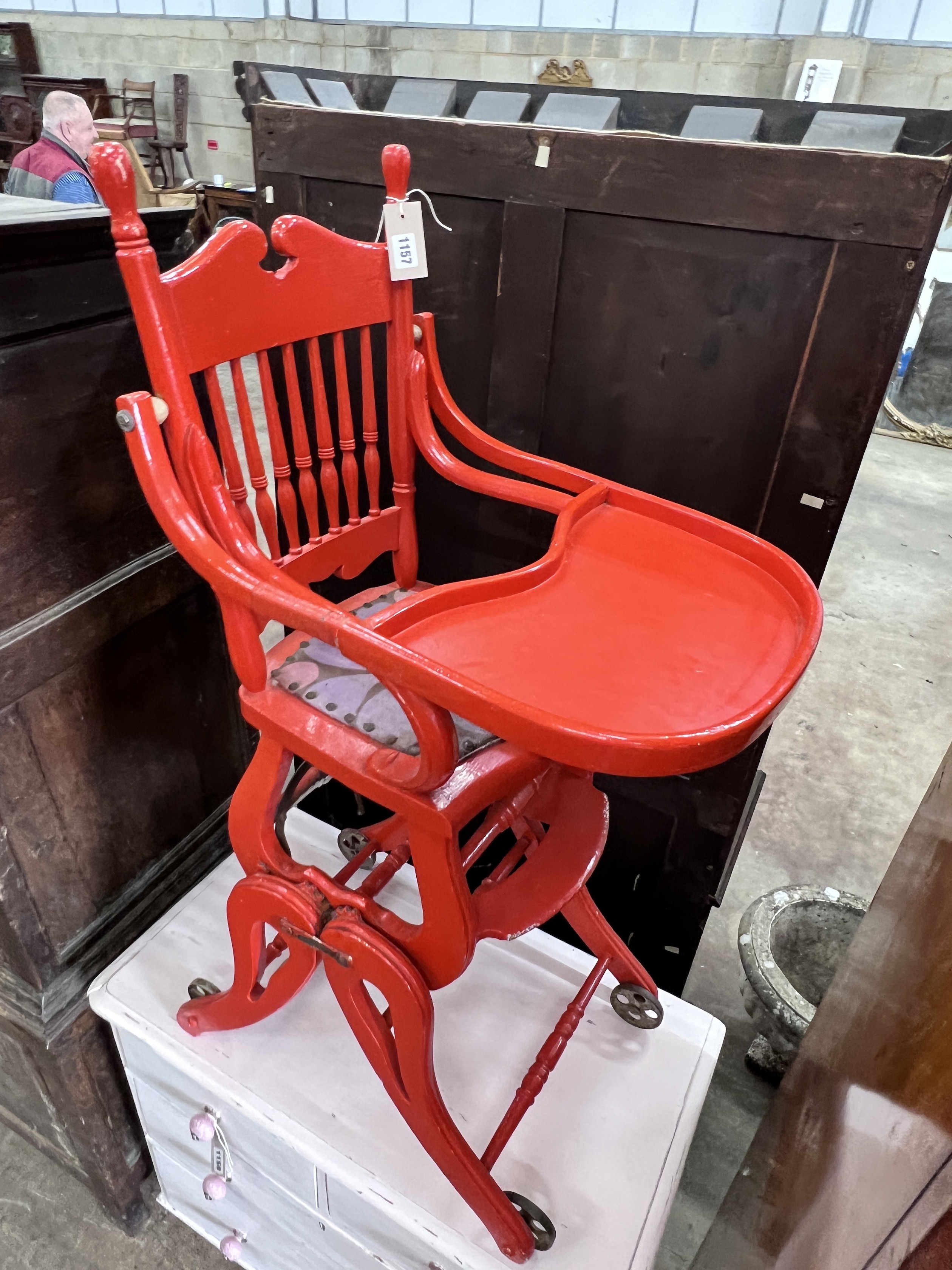 An early 20th century child's metamorphic high chair, later painted red